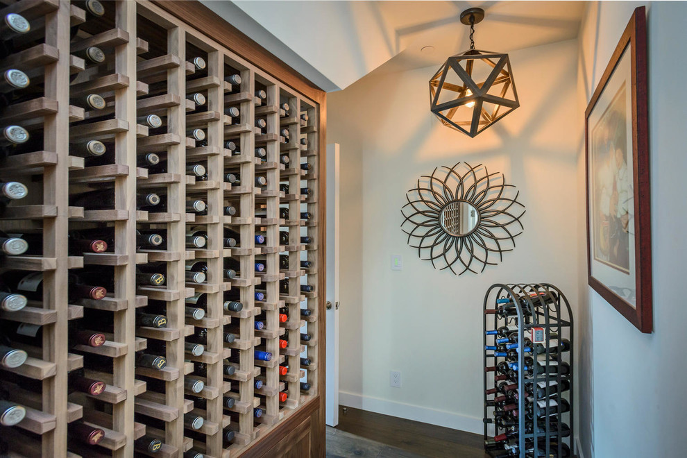 Inspiration for a small farmhouse wine cellar in San Francisco with dark hardwood flooring and storage racks.