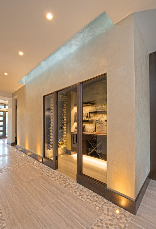 This is an example of a medium sized contemporary wine cellar in Vancouver with porcelain flooring, storage racks and beige floors.