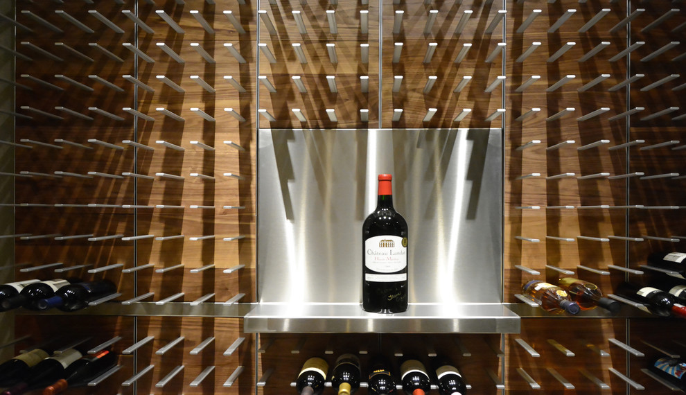 Inspiration for a large contemporary light wood floor wine cellar remodel in Tampa with storage racks