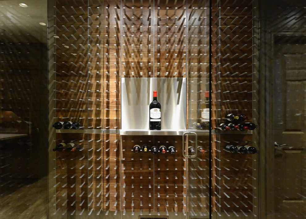 This is an example of a large contemporary wine cellar in Tampa with light hardwood flooring and storage racks.