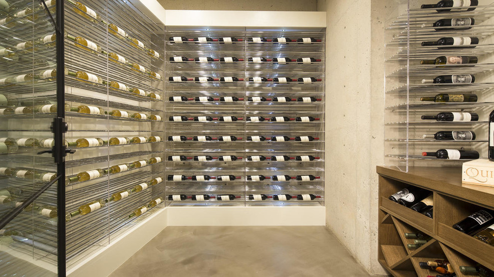 Inspiration for a contemporary wine cellar remodel in Orange County with display racks