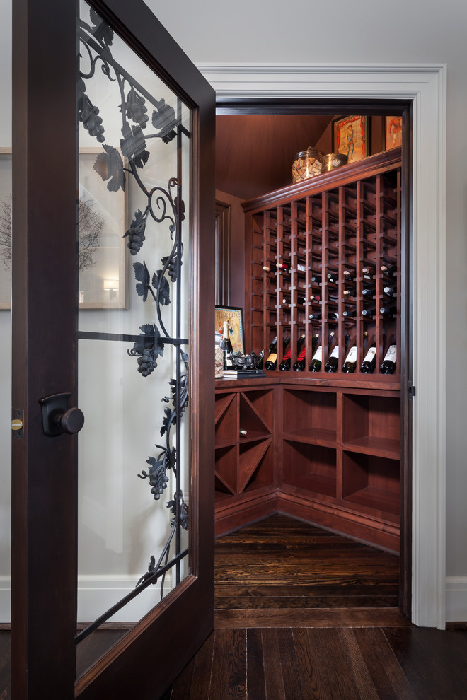 Inspiration for a small traditional wine cellar in Detroit with dark hardwood flooring and storage racks.