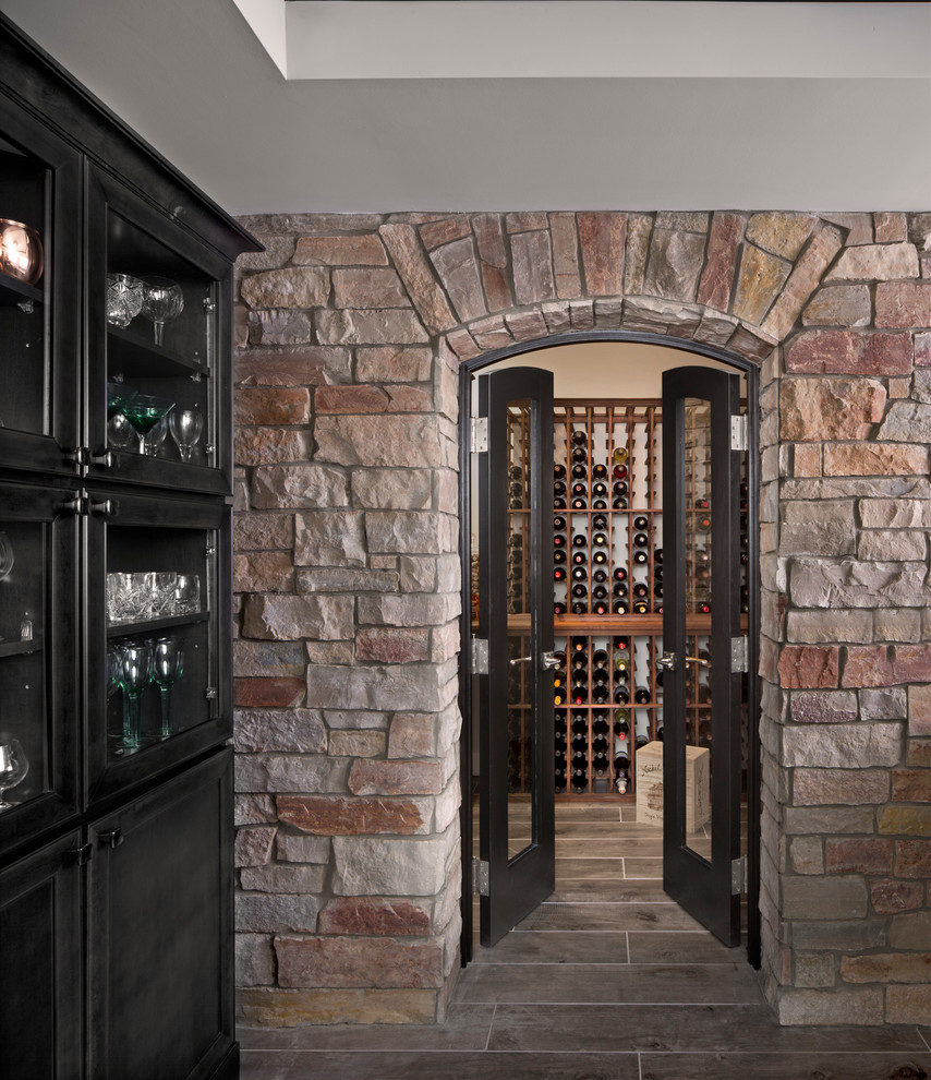 Inspiration for a large transitional wine cellar remodel in Detroit with storage racks