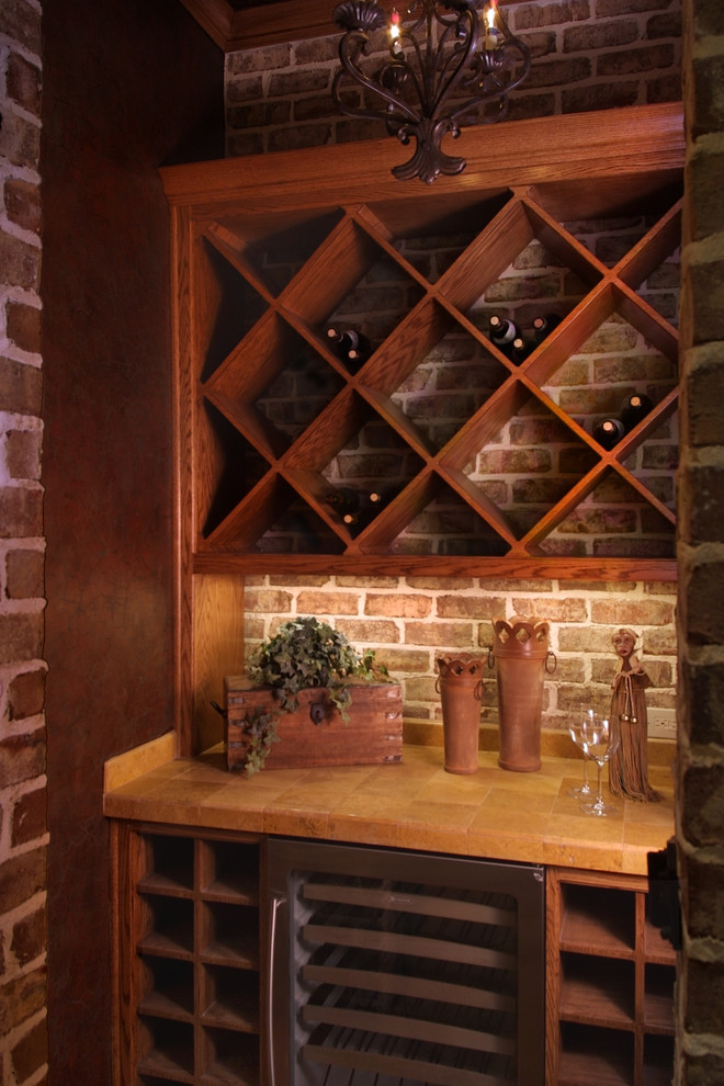Example of a mid-sized classic travertine floor wine cellar design in Houston with diamond bins