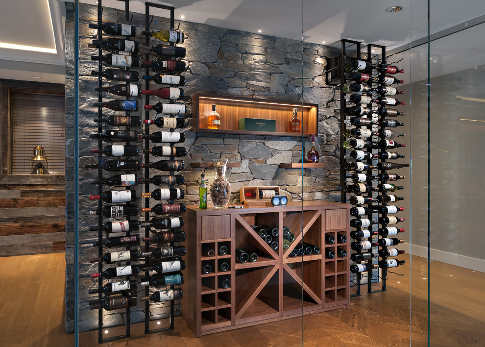 Contemporary wine cellar in Vancouver with dark hardwood flooring, cube storage and brown floors.
