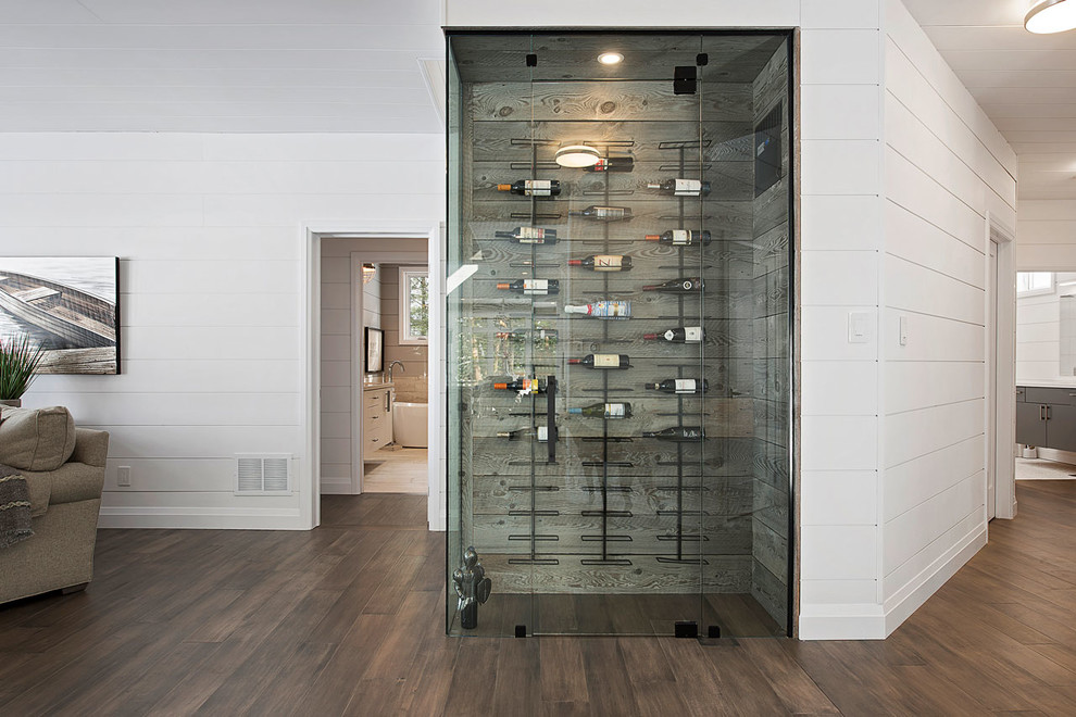 Inspiration for a small traditional wine cellar in Toronto with medium hardwood flooring, display racks and brown floors.