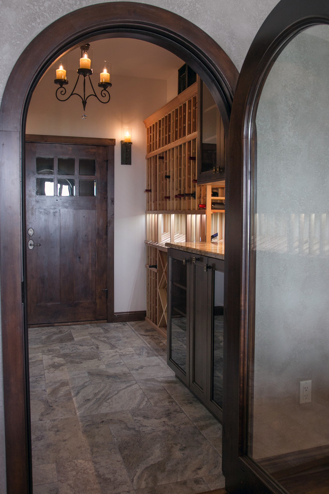 Wine cellar - mid-sized traditional ceramic tile and multicolored floor wine cellar idea in Milwaukee with storage racks