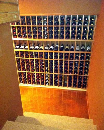 Wine cellar - mid-sized traditional wine cellar idea in Orange County with storage racks