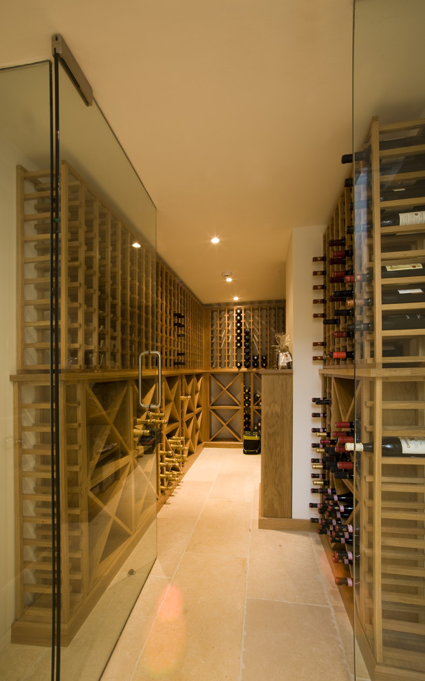 Inspiration for a large timeless limestone floor wine cellar remodel in Other with storage racks