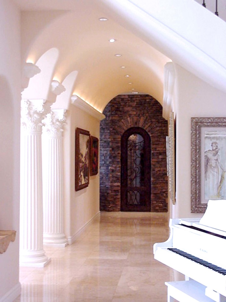 Example of a huge tuscan marble floor wine cellar design in Phoenix