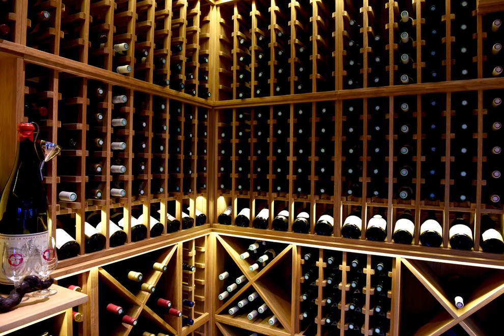 Design ideas for a large contemporary wine cellar in Other with storage racks, light hardwood flooring and brown floors.