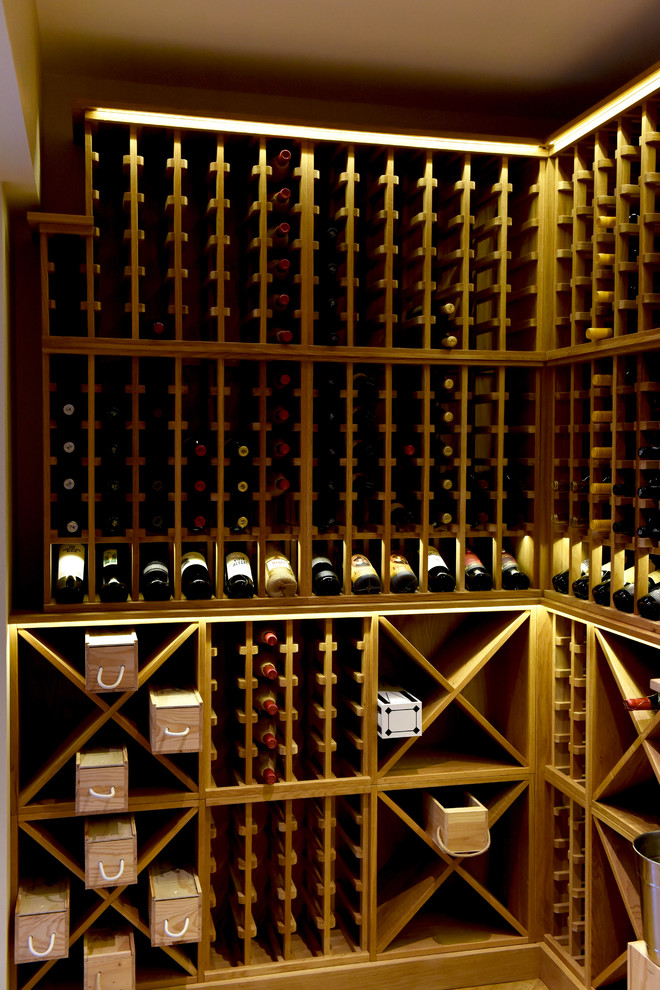 Inspiration for a large contemporary wine cellar in Other with storage racks, light hardwood flooring and brown floors.