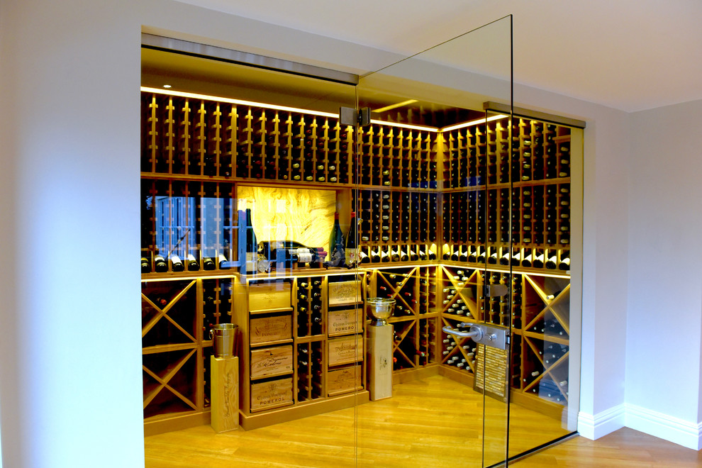 Wine cellar - large contemporary light wood floor and brown floor wine cellar idea in Other with storage racks
