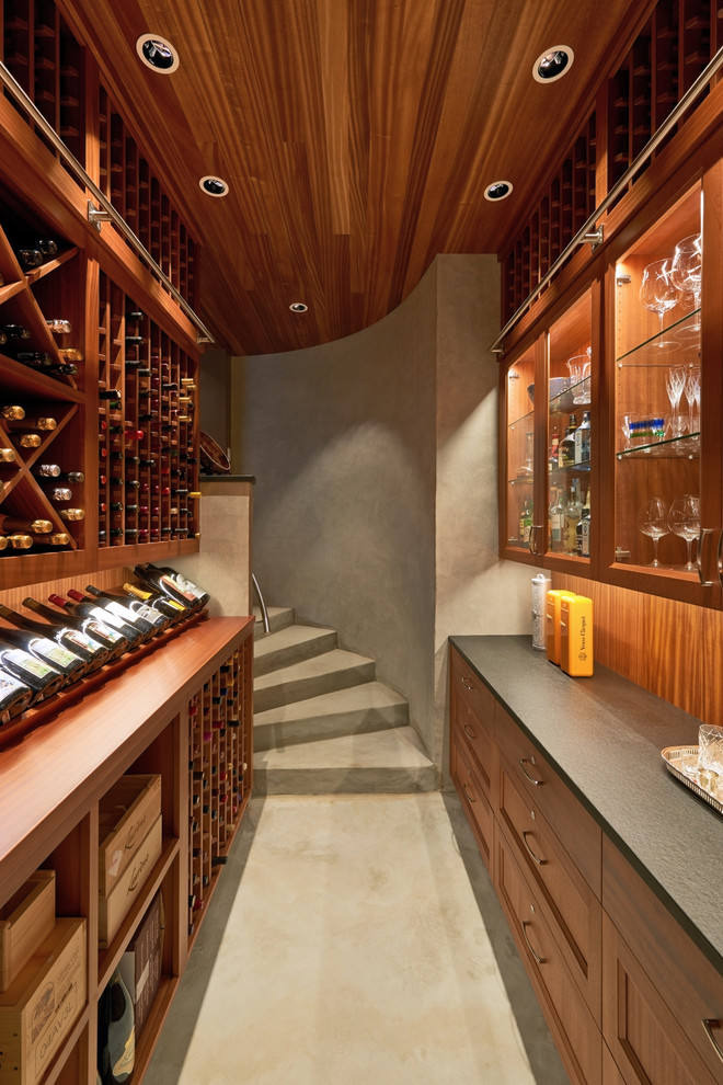 Inspiration for a mid-sized contemporary concrete floor wine cellar remodel in Portland with storage racks