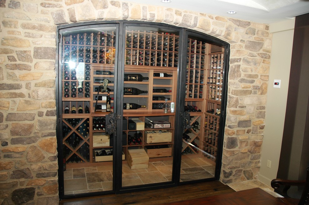 Example of a mid-sized cottage chic wine cellar design in San Diego with display racks
