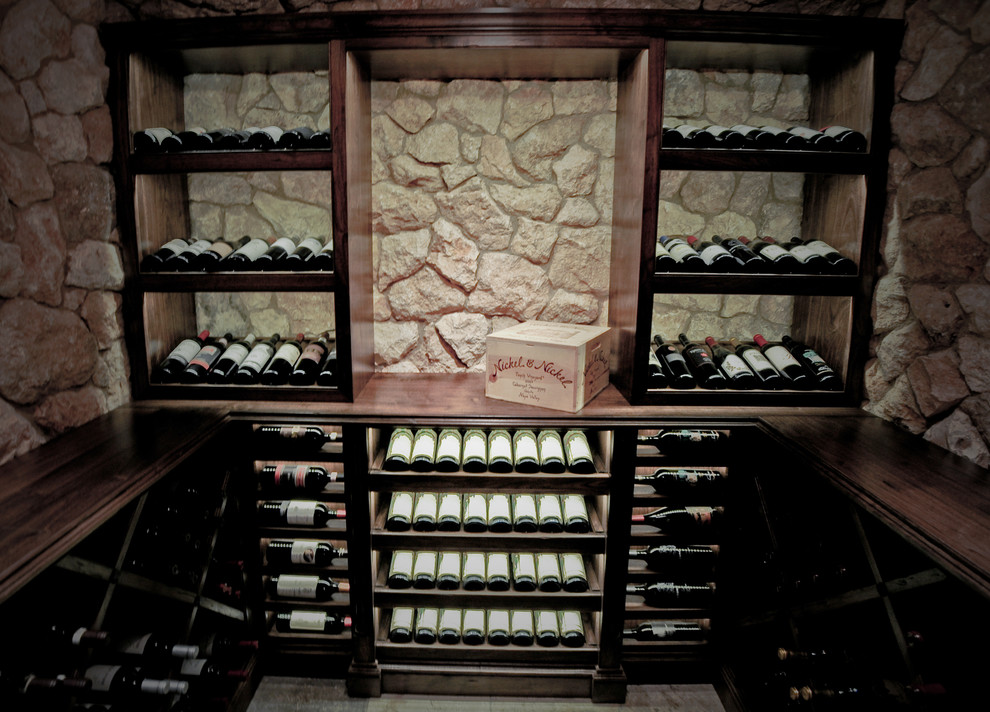 This is an example of a medium sized mediterranean wine cellar in San Diego with cube storage.