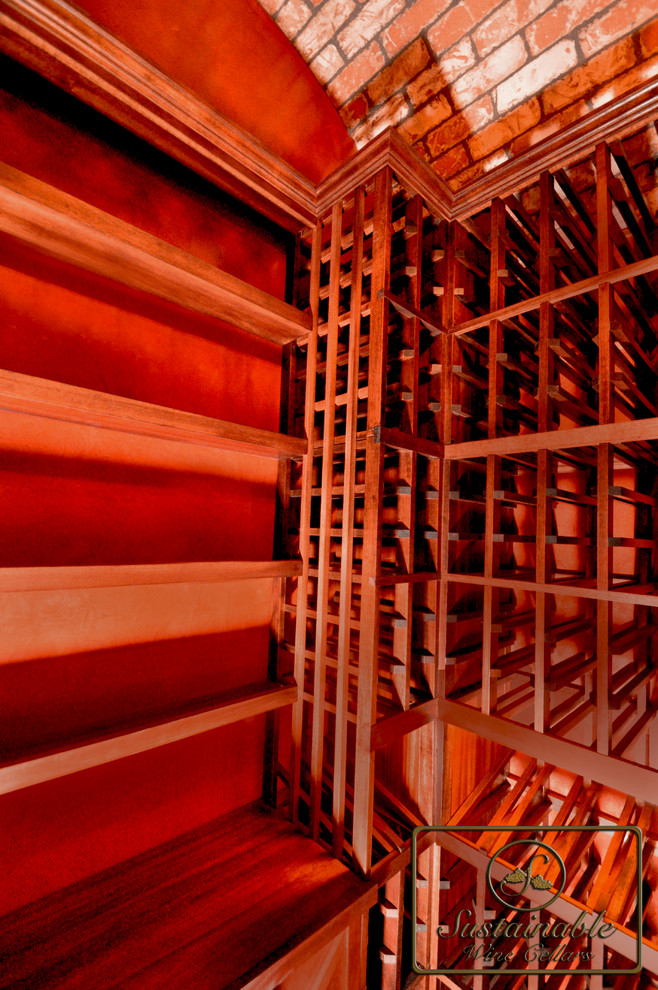 Small tuscan wine cellar photo in San Diego with display racks