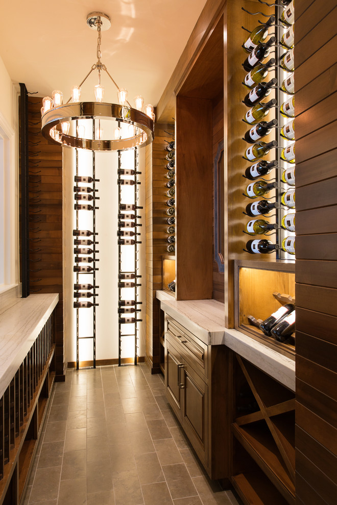 Design ideas for a small classic wine cellar in San Diego with limestone flooring, storage racks and brown floors.