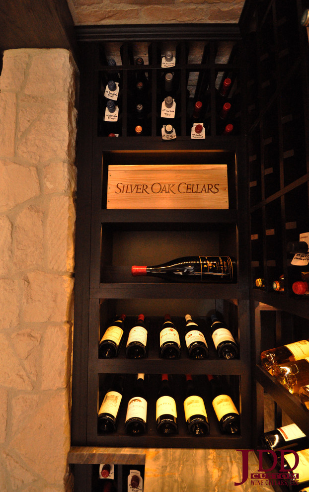 Inspiration for a large mediterranean concrete floor wine cellar remodel in San Diego with display racks