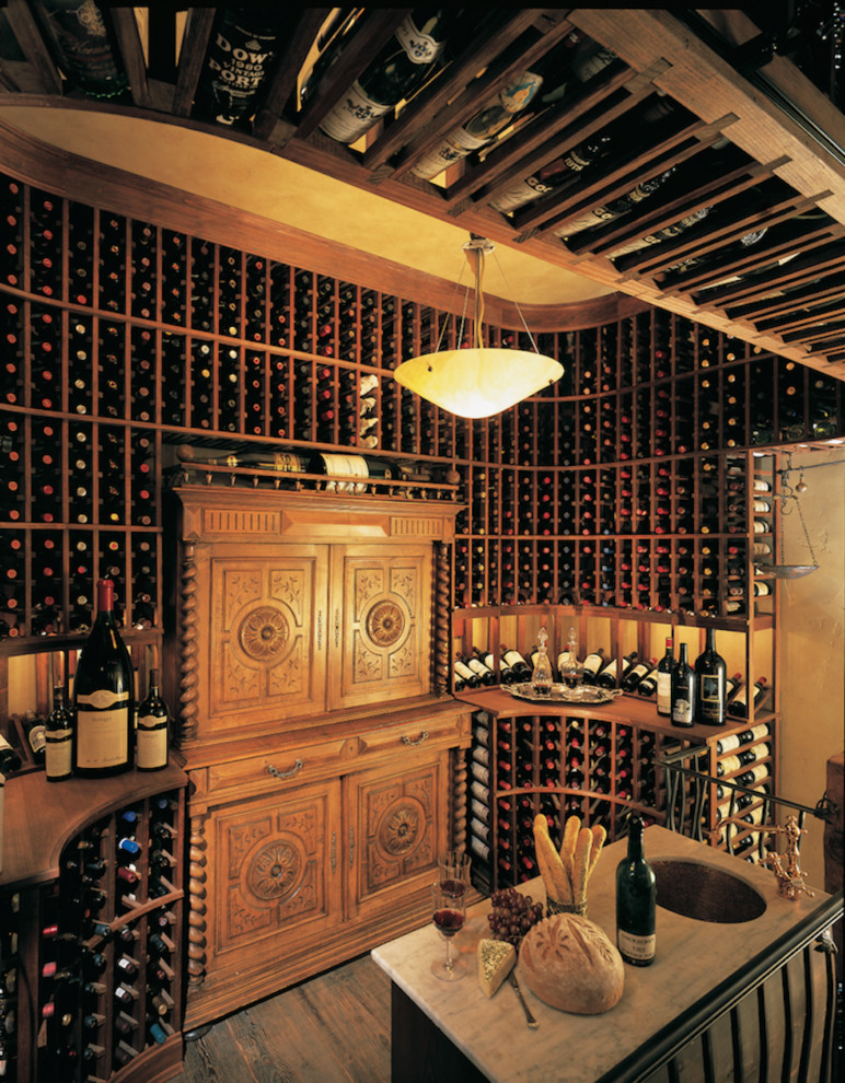 Large traditional wine cellar in San Diego with dark hardwood flooring.