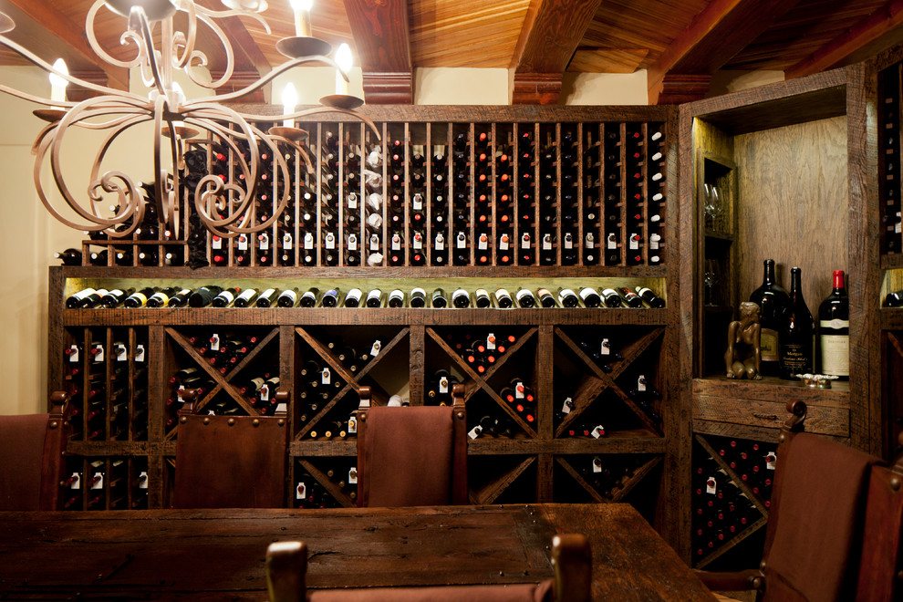 Photo of an expansive rustic wine cellar in San Diego with terracotta flooring, cube storage and brown floors.