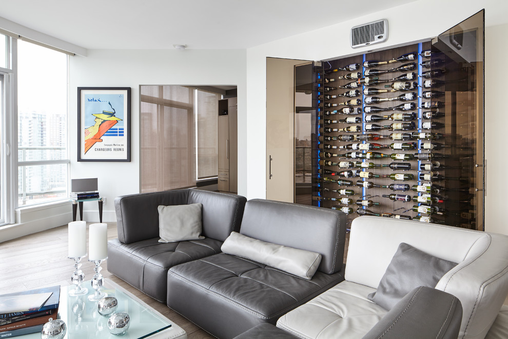 Inspiration for a mid-sized contemporary light wood floor and brown floor wine cellar remodel in Vancouver with display racks