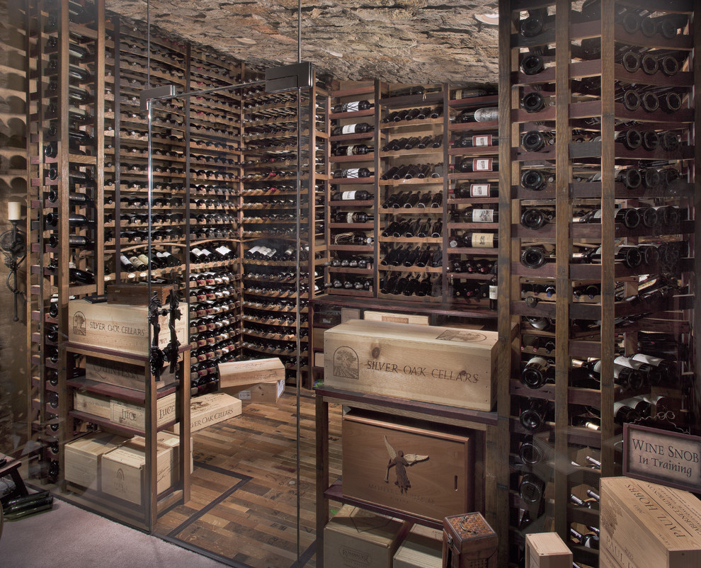 This is an example of a large rustic wine cellar in Phoenix with medium hardwood flooring, storage racks and brown floors.