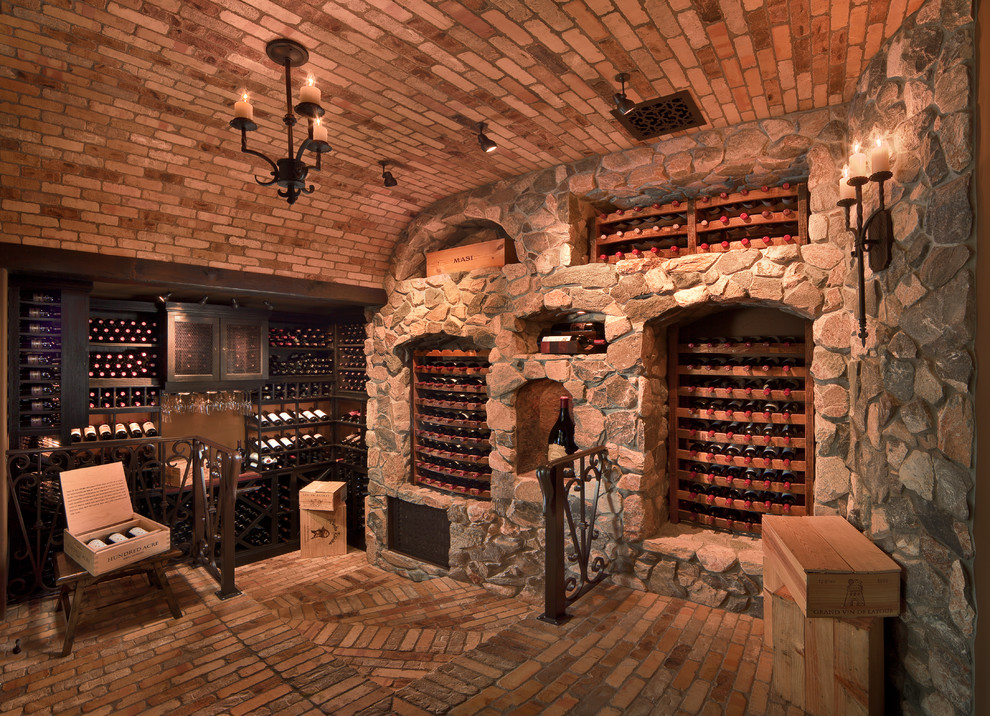 Inspiration for a mid-sized mediterranean brick floor and beige floor wine cellar remodel in Phoenix with storage racks