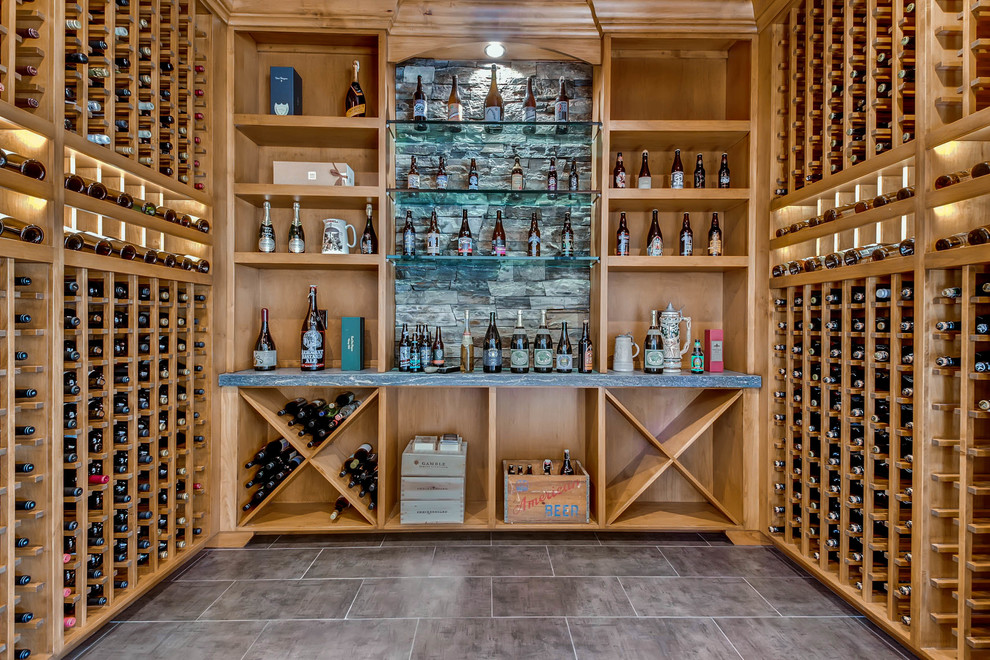 Photo of a contemporary wine cellar in San Diego with storage racks and grey floors.