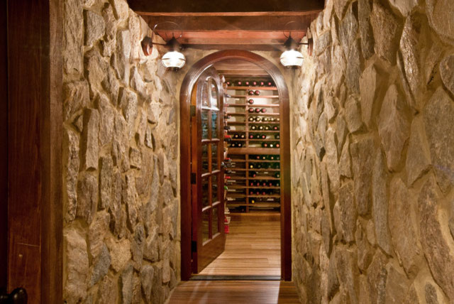 Großer Stilmix Weinkeller mit braunem Holzboden und Kammern in Boston