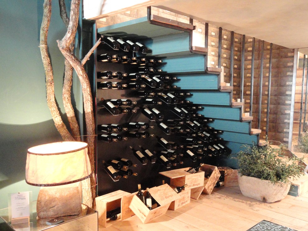 Aménagement d'une cave à vin industrielle de taille moyenne avec un présentoir, parquet clair et un sol marron.