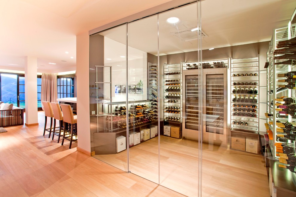 Inspiration for a medium sized contemporary wine cellar in Miami with light hardwood flooring, storage racks and yellow floors.