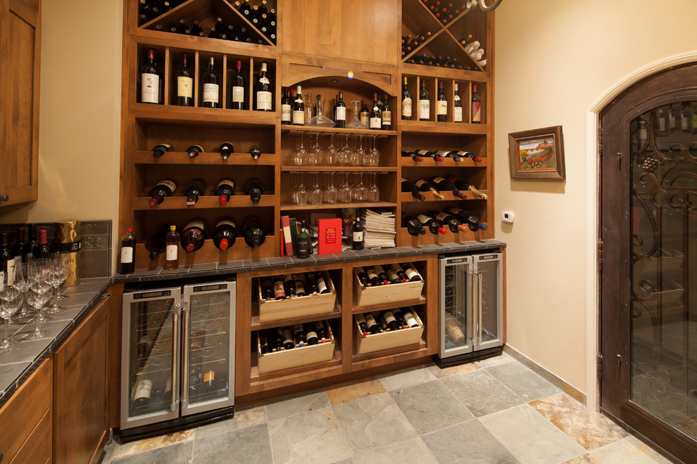 Photo of a medium sized traditional wine cellar in Los Angeles with slate flooring and cube storage.