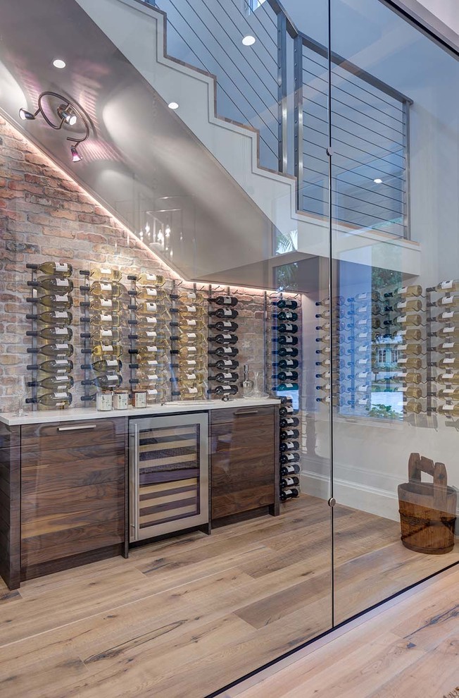 Inspiration for a mid-sized coastal medium tone wood floor wine cellar remodel in Other with storage racks
