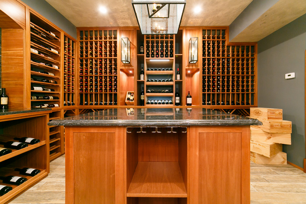 Example of a large classic porcelain tile wine cellar design in New York with display racks