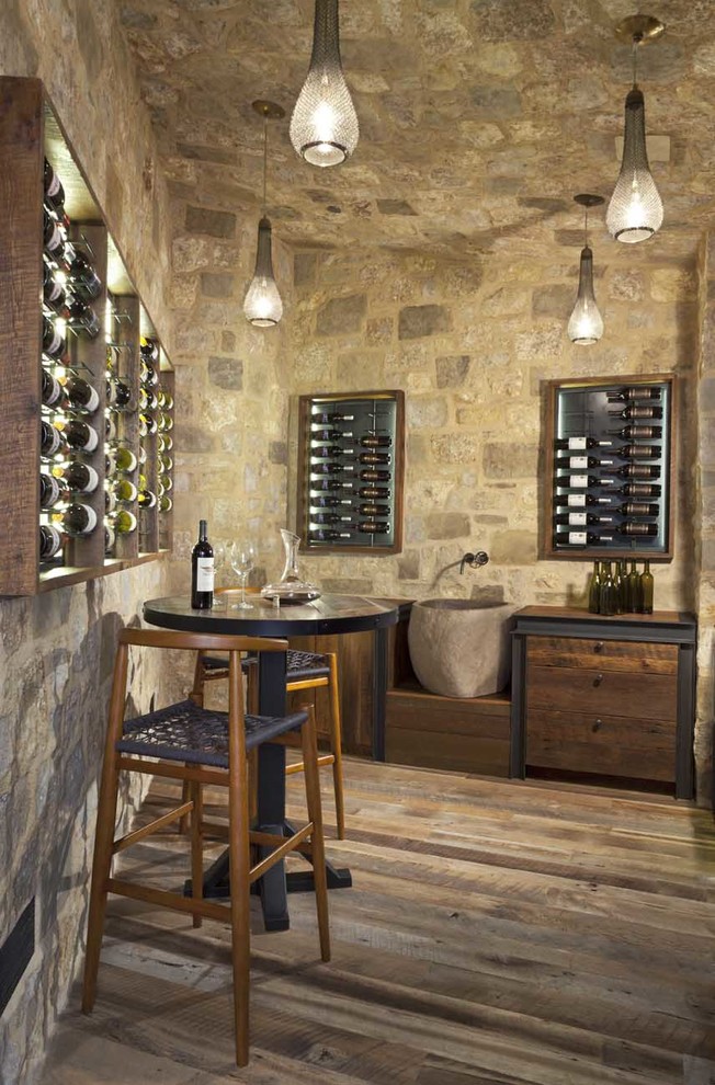 Photo of a large rustic wine cellar in Denver with medium hardwood flooring and display racks.
