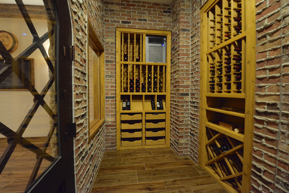Huge mountain style dark wood floor wine cellar photo in Indianapolis with storage racks