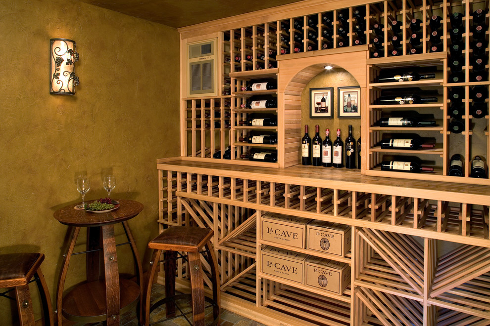 Inspiration for a mediterranean wine cellar remodel in Minneapolis with storage racks