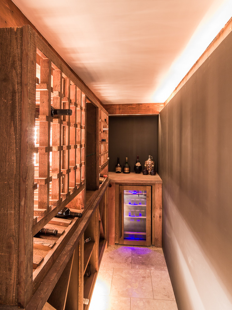 Photo of a medium sized rustic wine cellar in Minneapolis with travertine flooring and beige floors.