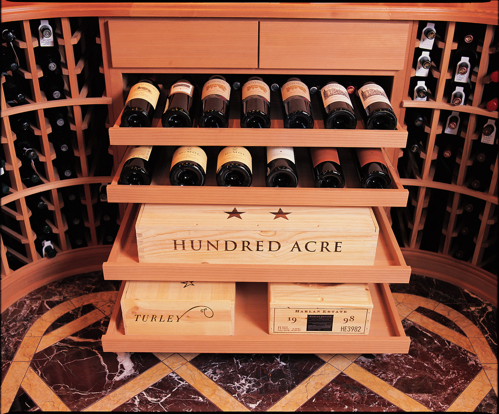 Wine cellar - large eclectic marble floor wine cellar idea in San Diego with display racks