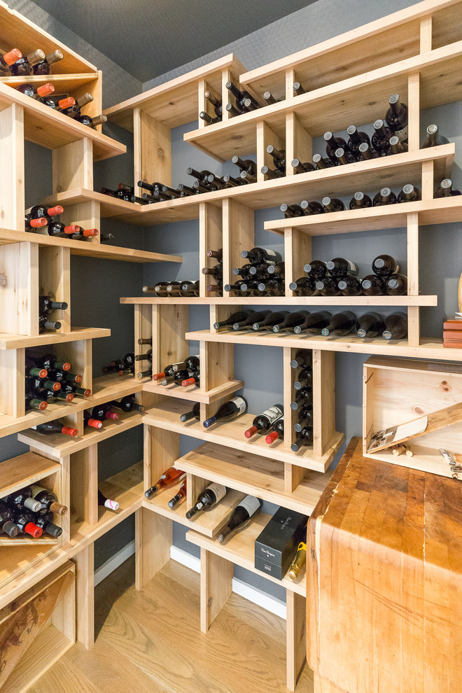 Small minimalist medium tone wood floor and gray floor wine cellar photo in Wilmington with storage racks