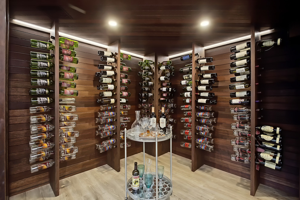 This is an example of a large classic wine cellar in Calgary with light hardwood flooring.