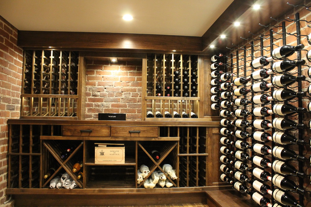 Design ideas for a medium sized rustic wine cellar in Denver with light hardwood flooring and display racks.