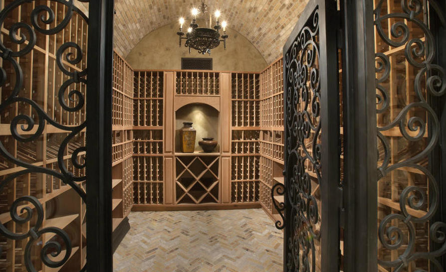 Huge tuscan porcelain tile and multicolored floor wine cellar photo in Phoenix with storage racks