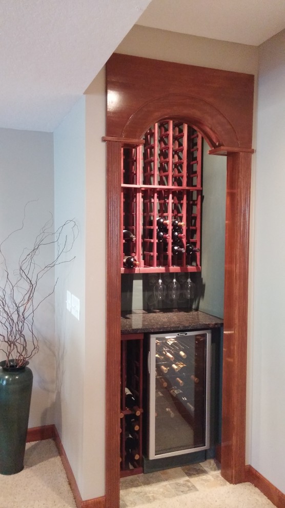 Design ideas for a small wine cellar in Cincinnati with storage racks.