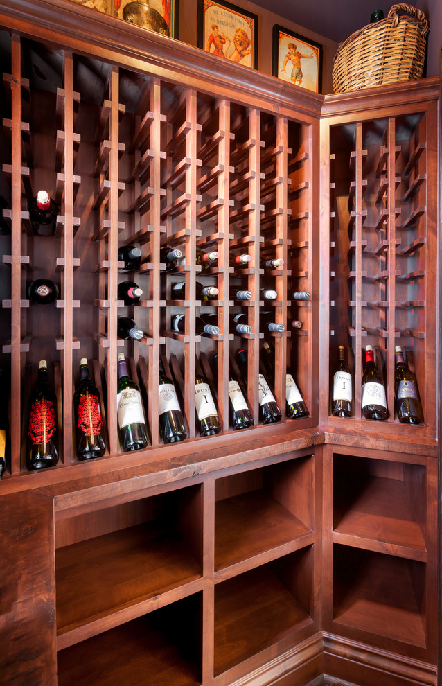 Photo of a small classic wine cellar in Detroit with medium hardwood flooring and storage racks.