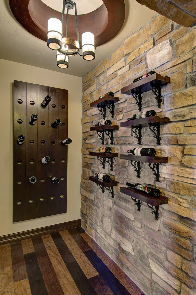 Example of a mid-sized classic dark wood floor and multicolored floor wine cellar design in Denver with display racks