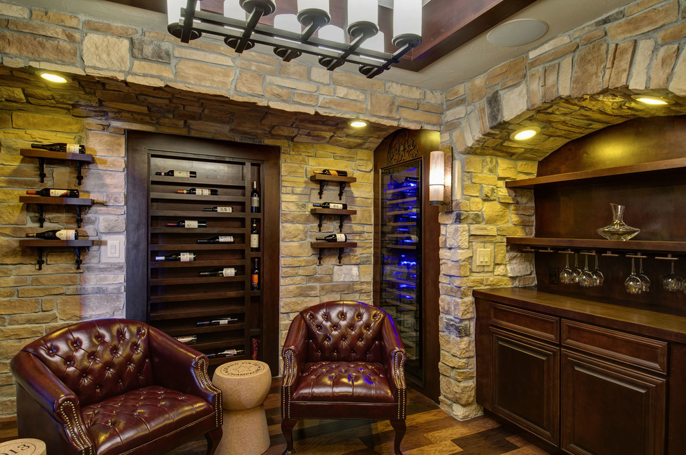 Example of a mid-sized classic dark wood floor and multicolored floor wine cellar design in Denver with display racks