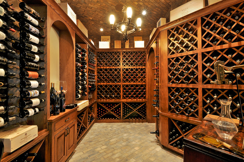 Wine cellar - huge traditional brick floor wine cellar idea in Austin with storage racks
