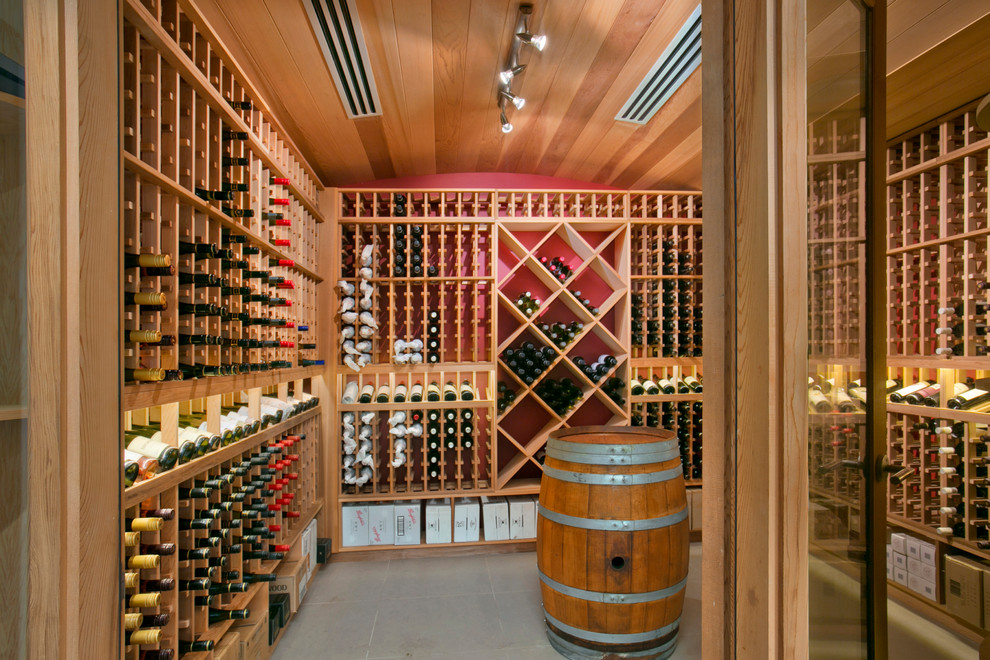 Inspiration for a mid-sized contemporary concrete floor wine cellar remodel in Sydney with storage racks